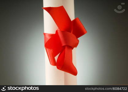 Education concept - diploma roll on the wooden table