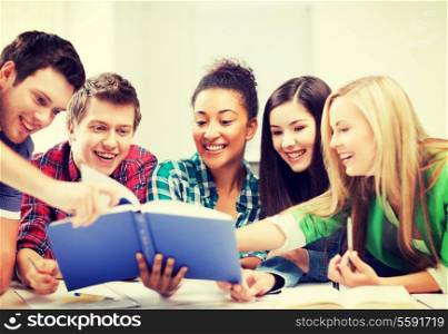 education concept - group of students reading book at school