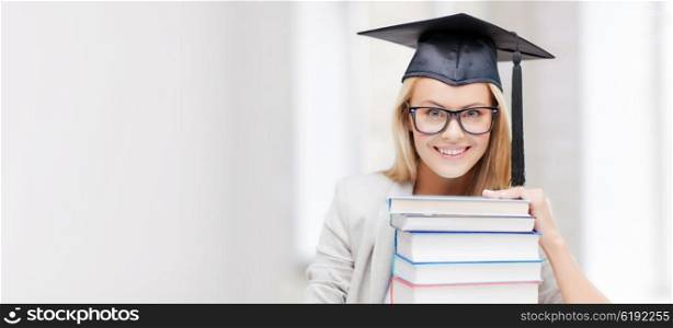 education concept - picture of happy student in graduation cap with stack of books. student in graduation cap