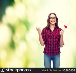 education concept - smiling female student in eyeglasses with diploma