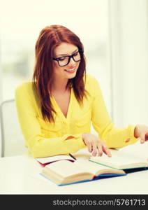 education concept - smiling student girl in eyeglasses reading books in college