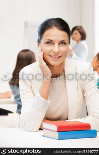 education concept - smiling student girl with book at school