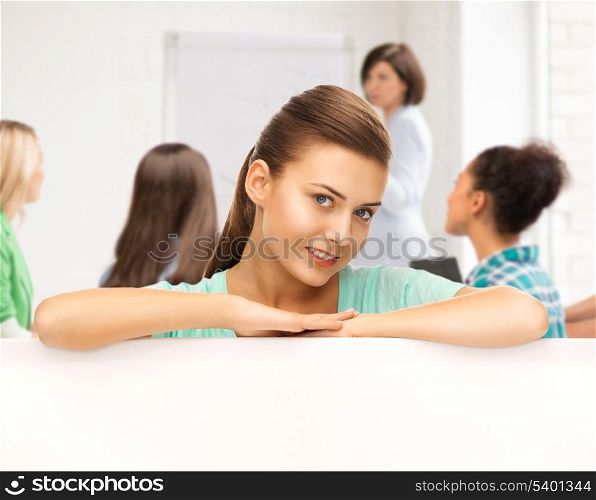education concept - smiling student girl with white blank board