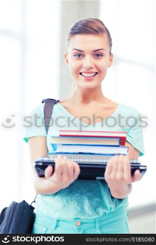 education concept - smiling student with folders and school bag in college. student with folders and school bag in college