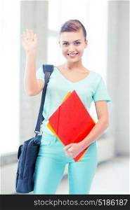 education concept - smiling student with folders and school bag in college. student with folders and school bag in college