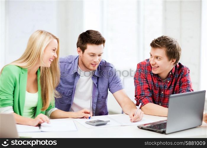 education concept - smiling students chatting in lecture at school
