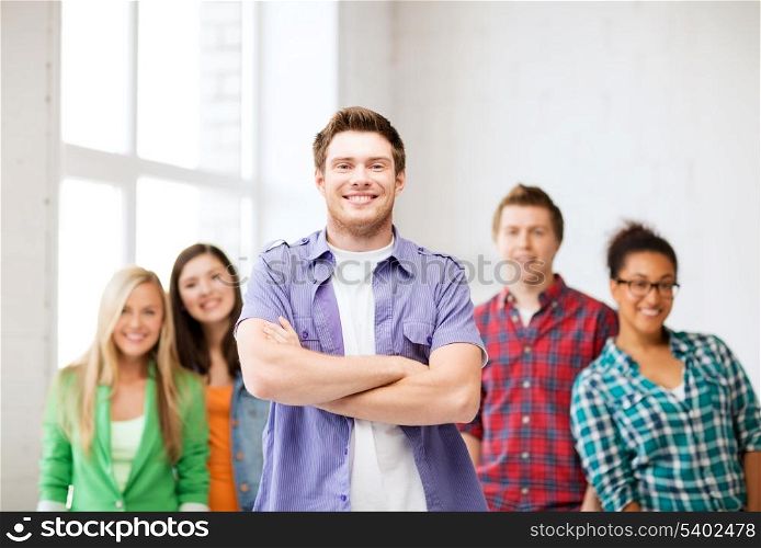 education concept - student boy with group of students at school