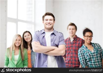 education concept - student boy with group of students at school