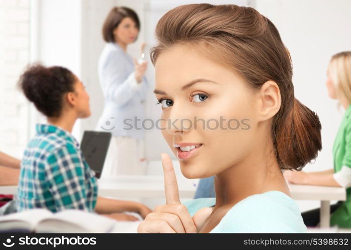 education concept - student girl making hush gesture at school