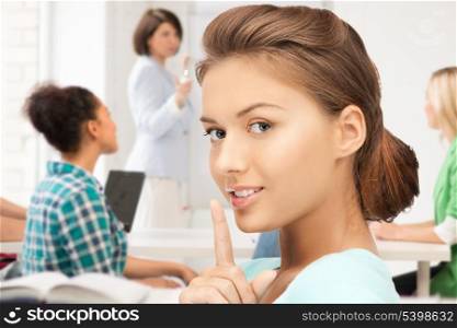 education concept - student girl making hush gesture at school
