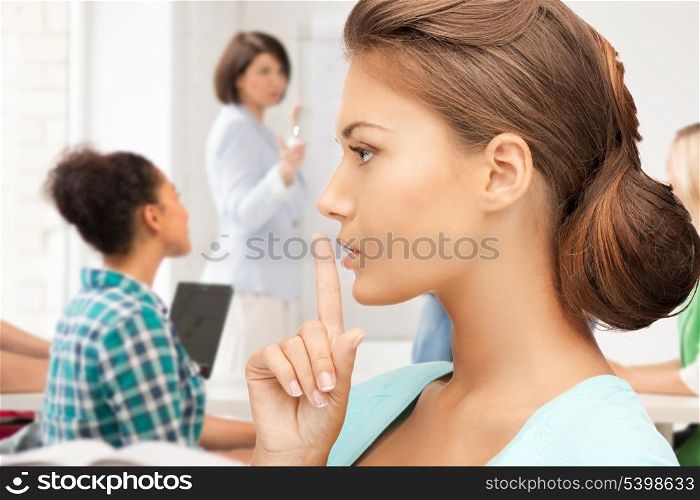 education concept - student girl making hush gesture at school