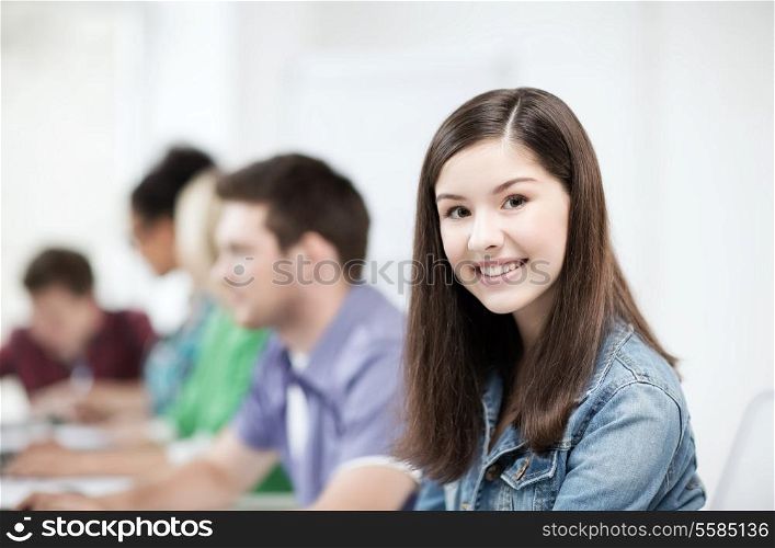 education concept - student girl with computer studying at school