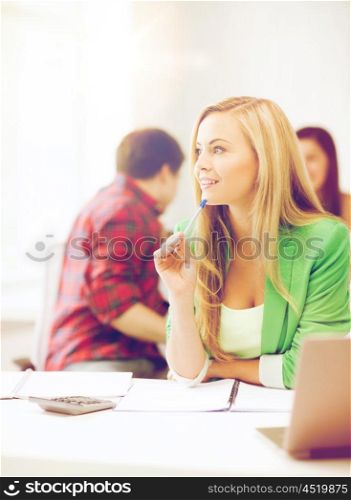 education concept - student girl with notebook and calculator in college. student girl with notebook and calculator