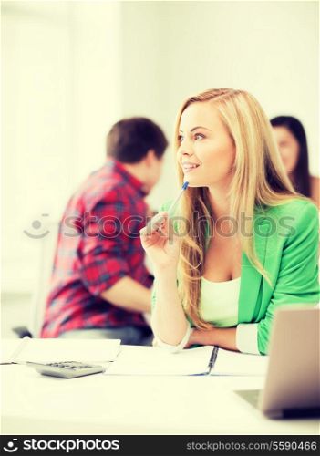 education concept - student girl with notebook and calculator in college