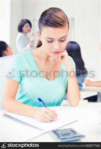 education concept - student girl with notebook and calculator. student girl with notebook and calculator