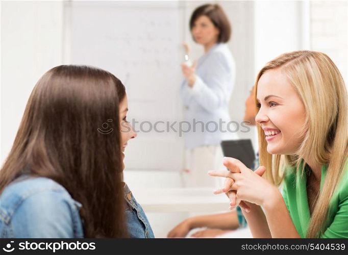 education concept - student girls gossiping at school
