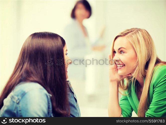 education concept - student girls gossiping at school