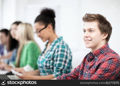 education concept - student with computer studying at school