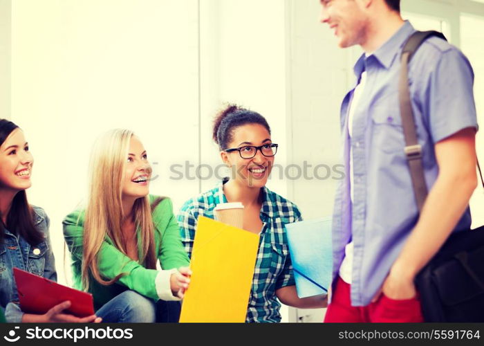 education concept - students communicating and laughing at school