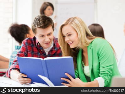 education concept - students reading book at school