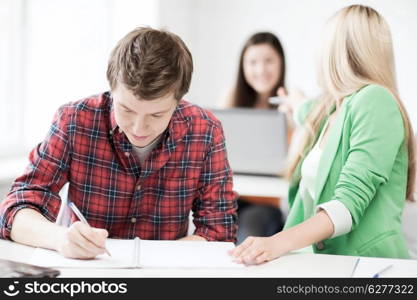education concept - students writing something at school