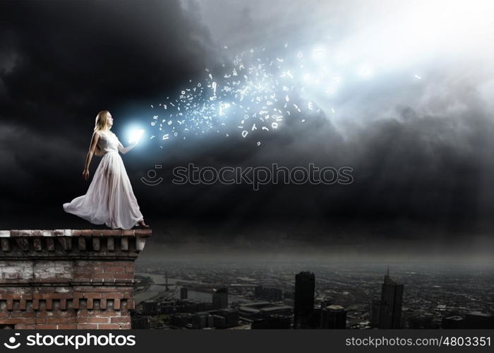 Education concept. Woman in white long dress with book in hands