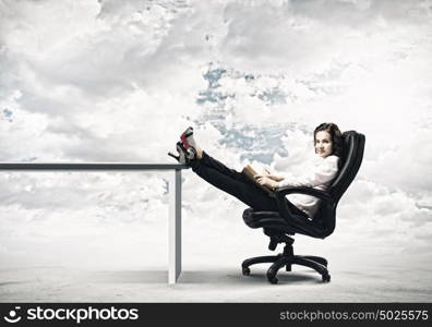 Education concept. Young businesswoman sitting in chair and reading book