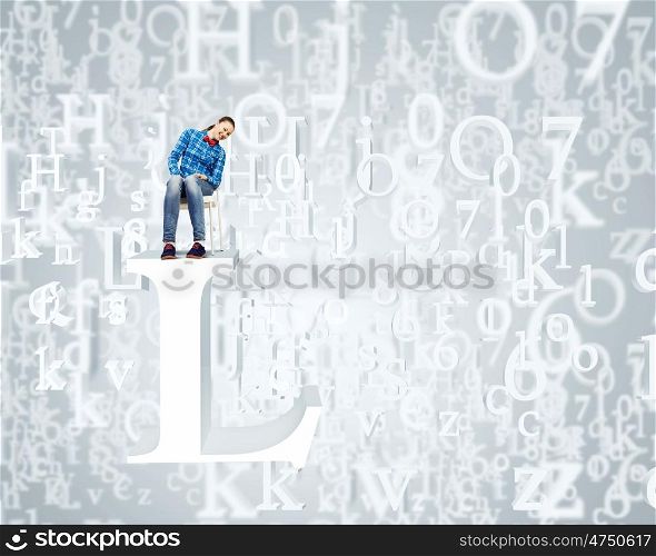 Education concept. Young girl sitting on huge white letter