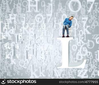 Education concept. Young girl sitting on huge white letter