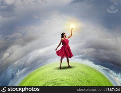 Education concept. Young woman in blindfold standing on green Earth