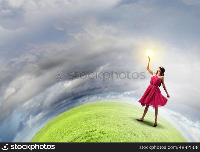 Education concept. Young woman in blindfold standing on green Earth