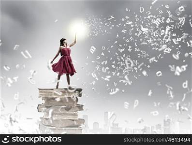 Education concept. Young woman in blindfold standing on pile of books