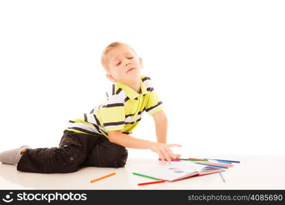 Education, creation and school concept - little boy child drawing with color pencils isolated
