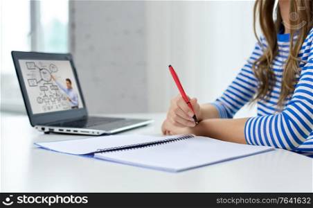education, e-learning and school concept - close up of student girl with exercise book, pen and teacher on laptop computer having online lesson at home. student girl with exercise book, pen and laptop