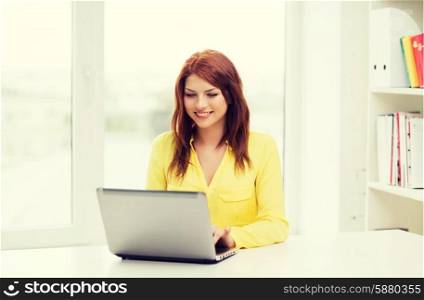 education, e-learning and technology concept - smiling student with laptop computer at school