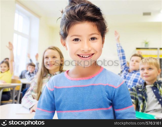 education, elementary school and children concept - little student girl over classroom and classmates background