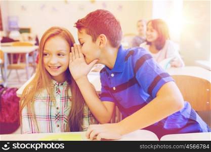 education, elementary school, learning and people concept - smiling schoolboy whispering secret to classmate ear in classroom
