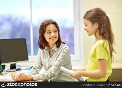 education, elementary school, learning, examination and people concept - school girl with notebook and teacher in classroom