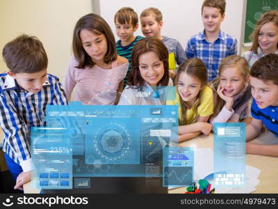 education, elementary school, learning, technology and people concept - group of kids with teacher looking to computer monitor in classroom over virtual screens projections. group of kids with teacher and computer at school