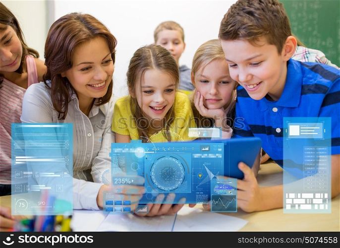 education, elementary school, learning, technology and people concept - group of kids with teacher looking to tablet pc computer in classroom over virtual screens projections. group of kids with teacher and tablet pc at school