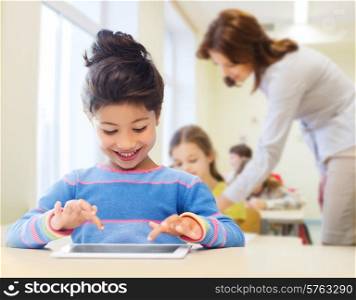education, elementary school, technology and children concept - happy little student girl with tablet pc over classroom and teacher background