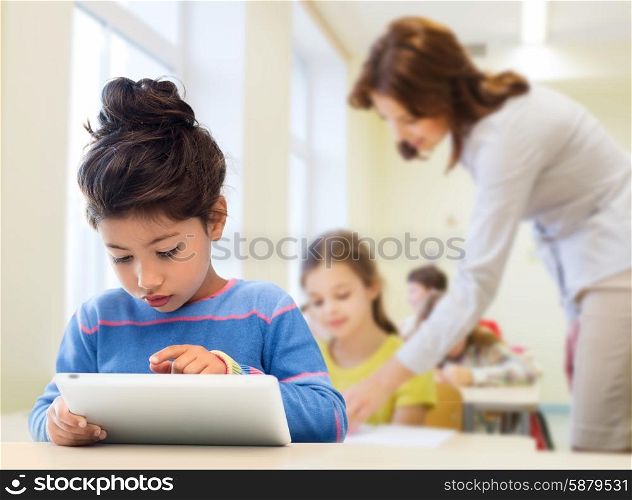 education, elementary school, technology and children concept - little student girl with tablet pc over classroom and teacher background