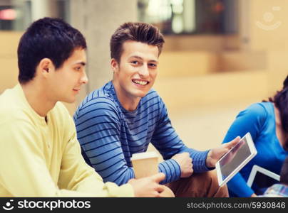 education, friendship, technology, drinks and people concept - group of smiling students with tablet pc computers and paper coffee cup