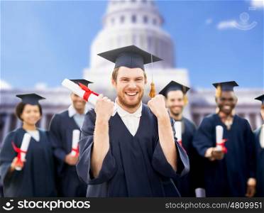 education, gesture and people concept - group of happy international students in mortar boards and bachelor gowns with diplomas celebrating successful graduation over american white house background