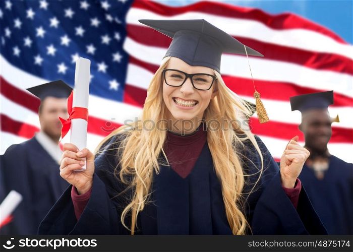 education, gesture and people concept - group of happy international students in mortarboards and bachelor gowns with diplomas celebrating successful graduation over american flag background
