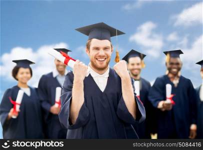 education, gesture and people concept - group of happy international students in mortar boards and bachelor gowns with diplomas celebrating successful graduation over blue sky and clouds background. happy student with diploma celebrating graduation. happy student with diploma celebrating graduation