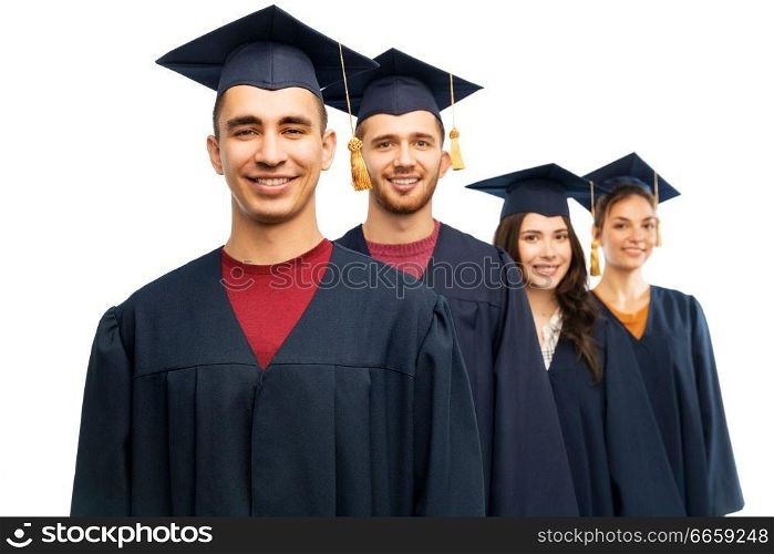 education, graduation and people concept - group of happy graduate students in mortar boards and bachelor gowns over white background. graduates in mortar boards and bachelor gowns