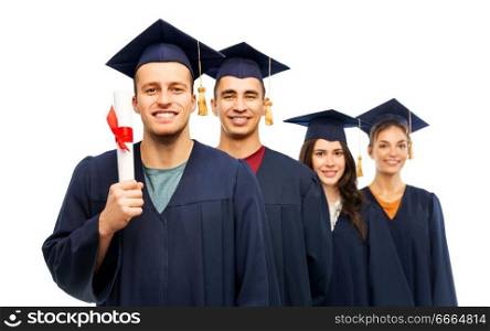education, graduation and people concept - group of happy graduate students in mortar boards and bachelor gowns with diploma over white background. graduates in mortar boards with diploma