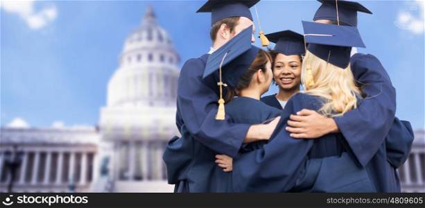education, graduation and people concept - group of happy international students in mortar boards and bachelor gowns hugging over american white house background