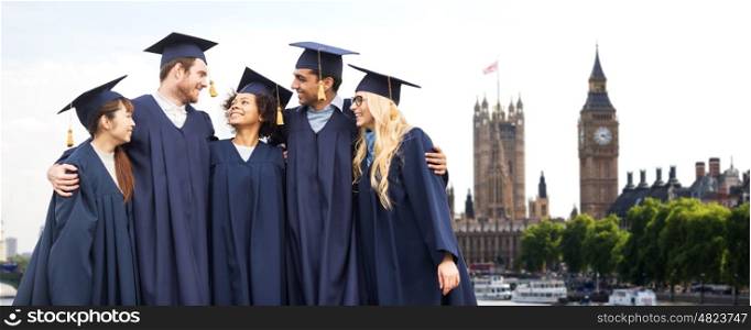 education, graduation and people concept - group of happy international students in mortar boards and bachelor gowns over london city background